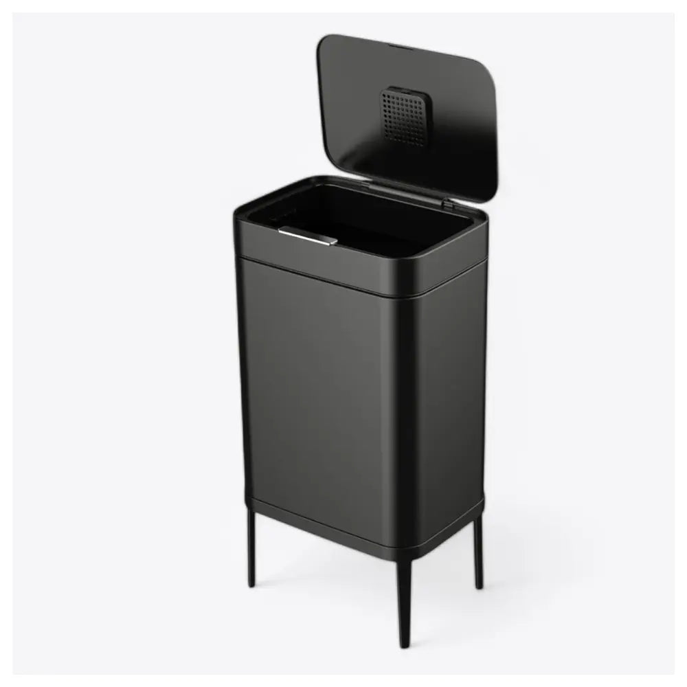The lano PressOpen פח אשפה נפתח בלחיצה בנפח 60 ליטר, גבוה ומלבני בצבע שחור אלגנטי עם מכסה פתוח, עומד על ארבע רגליים דקיקות על רקע לבן חלק.
